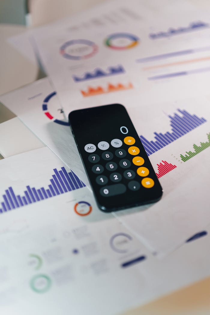 Services-01 Calculator on graphs showing financial data and analytics. Ideal for business and finance themes.